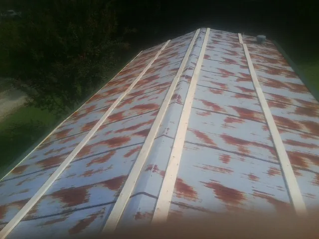 Rusted metal roof panels with new wood purlins before replacement — Storm Damage Roof Repair in Hydes by Roofing Brothers